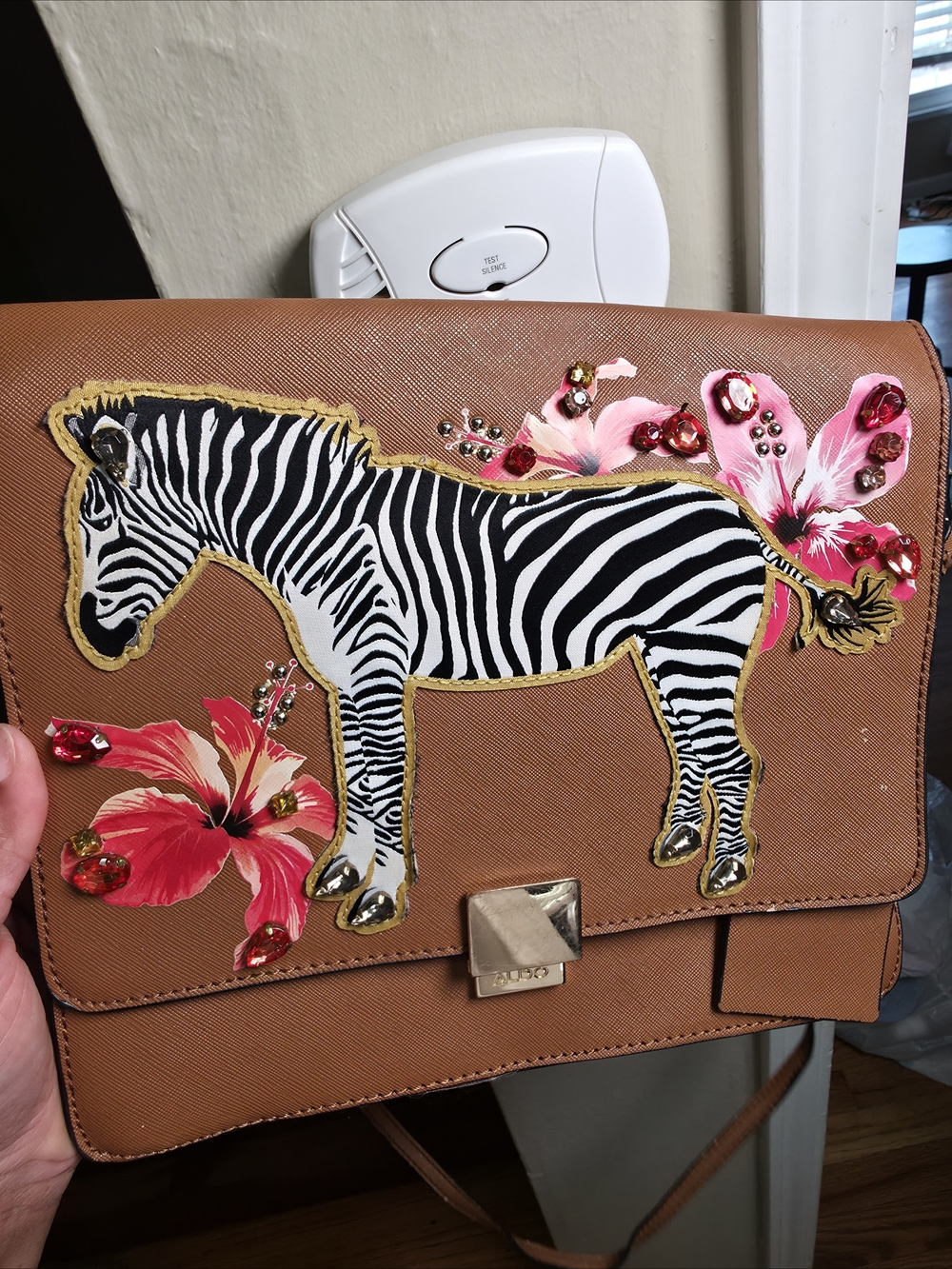 Aldo Tan Crossbody with Zebra Patch and Pink Floral Accents